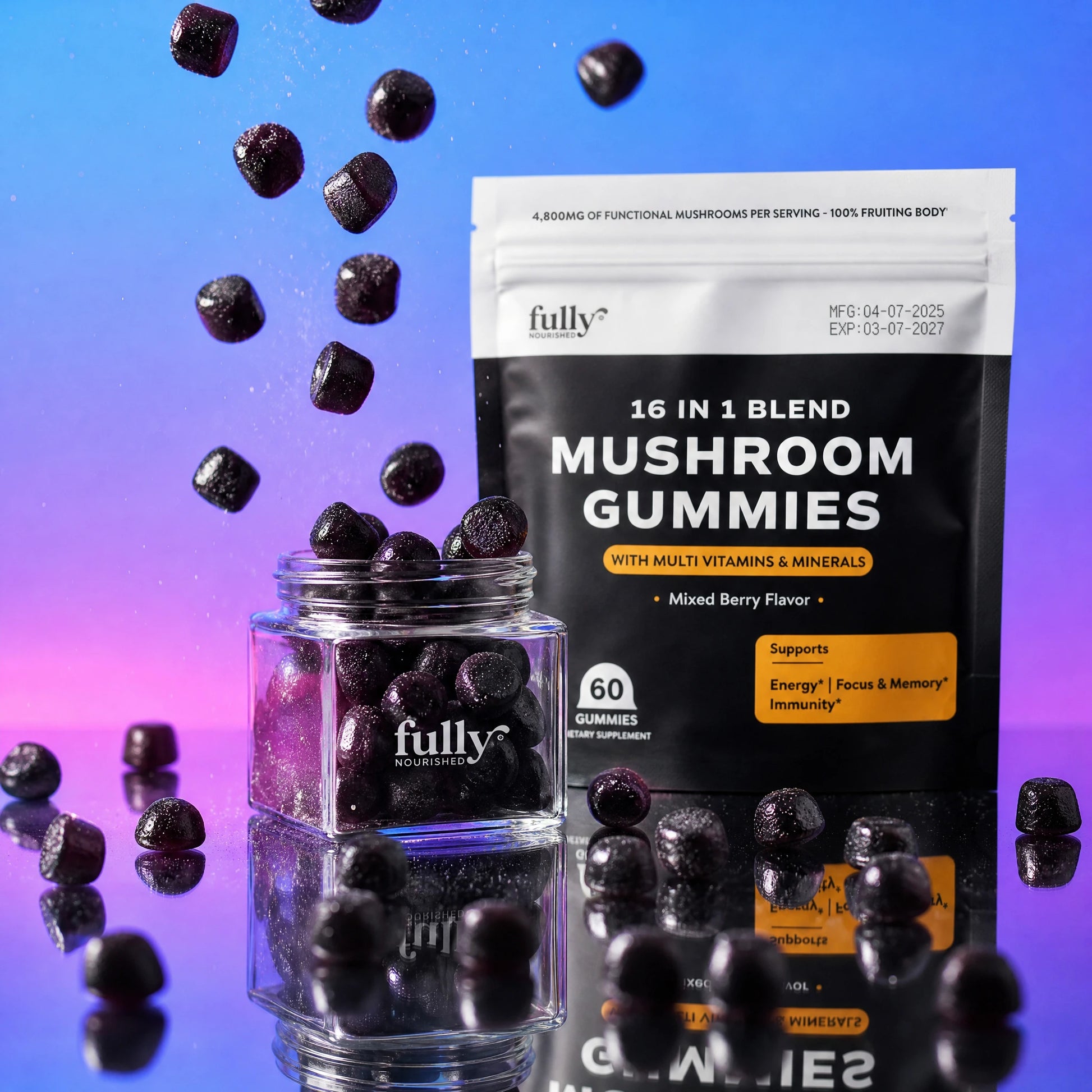 A glass jar and a package of Fully Nutrition 16 in 1 Mushroom Gummies, with several gummies falling and scattered on a reflective surface, set against a gradient purple and blue background.